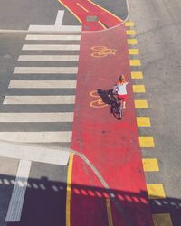 High angle view of woman riding bicycle on street