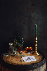 Dark still life with manhattan cocktail on whiskey barrel