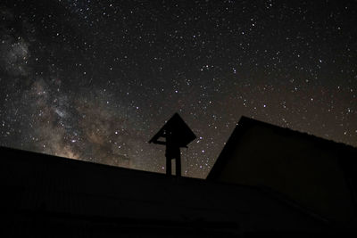 Low angle view of clock tower against sky at night