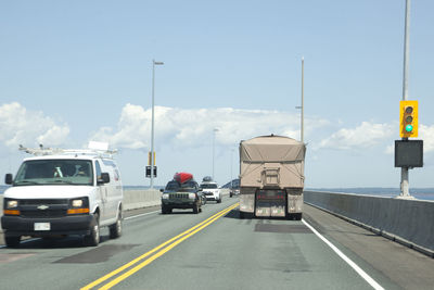 Cars on road against sky