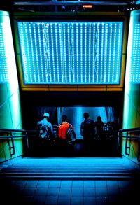 People in illuminated room