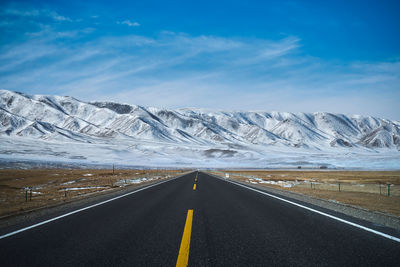 The road to the snow-capped mountains