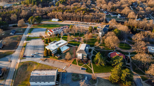 High angle view of trees and buildings in city