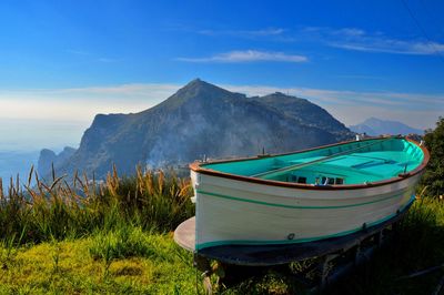 Scenic view of sea and mountains against sky