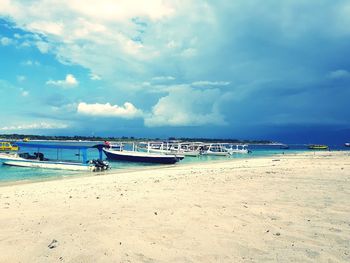 Scenic view of beach against cloudy sky