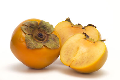 Close-up of orange fruit against white background