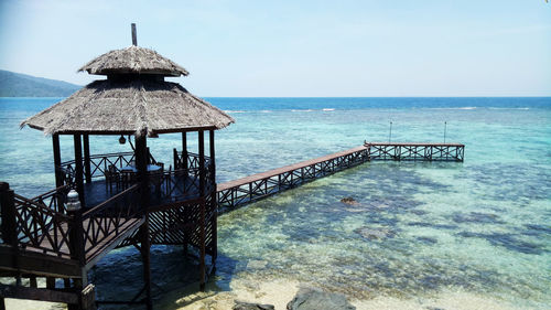 Gazebo by sea against sky