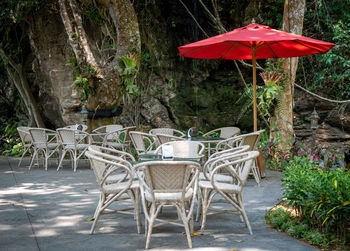 Empty chairs and tables in yard