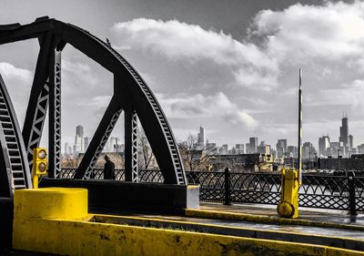 View of bridge over river against cloudy sky
