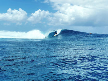 Scenic view of sea against sky and surf 