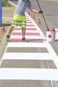 Low section of person crossing road