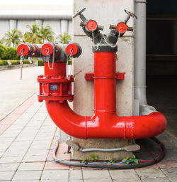 Red fire hydrant on footpath