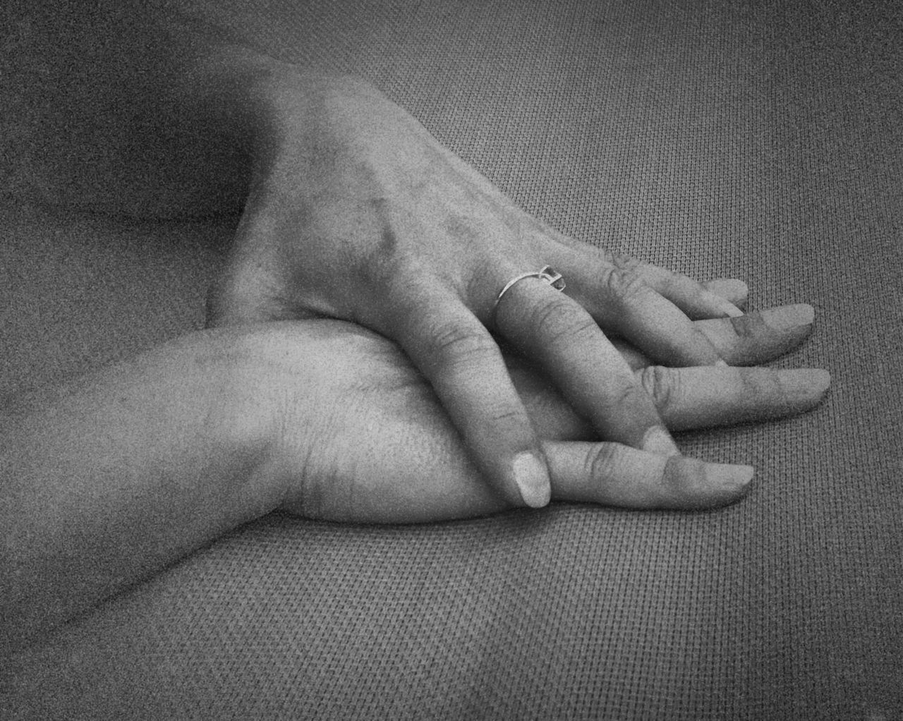 MIDSECTION OF COUPLE HANDS ON BABY