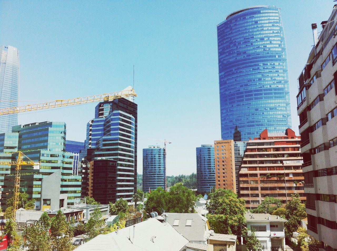 building exterior, architecture, built structure, city, clear sky, skyscraper, modern, office building, tall - high, tower, building, cityscape, low angle view, city life, blue, development, residential building, day, financial district, tall