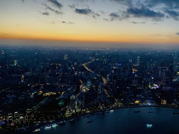 Aerial view of illuminated buildings in city at night