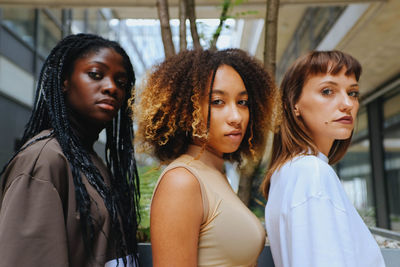 Portrait of friends standing at home