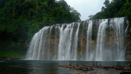 Beautiful waterfall in green forest. tropical tinuy-an falls in mountain jungle, philippines 