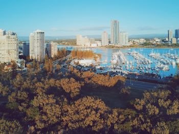 Scenic view of river by buildings against sky