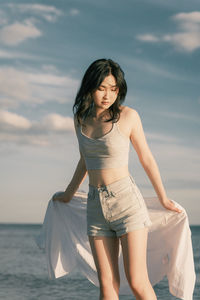 Young woman sitting on beach