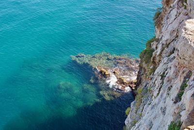 High angle view of rocks at sea shore