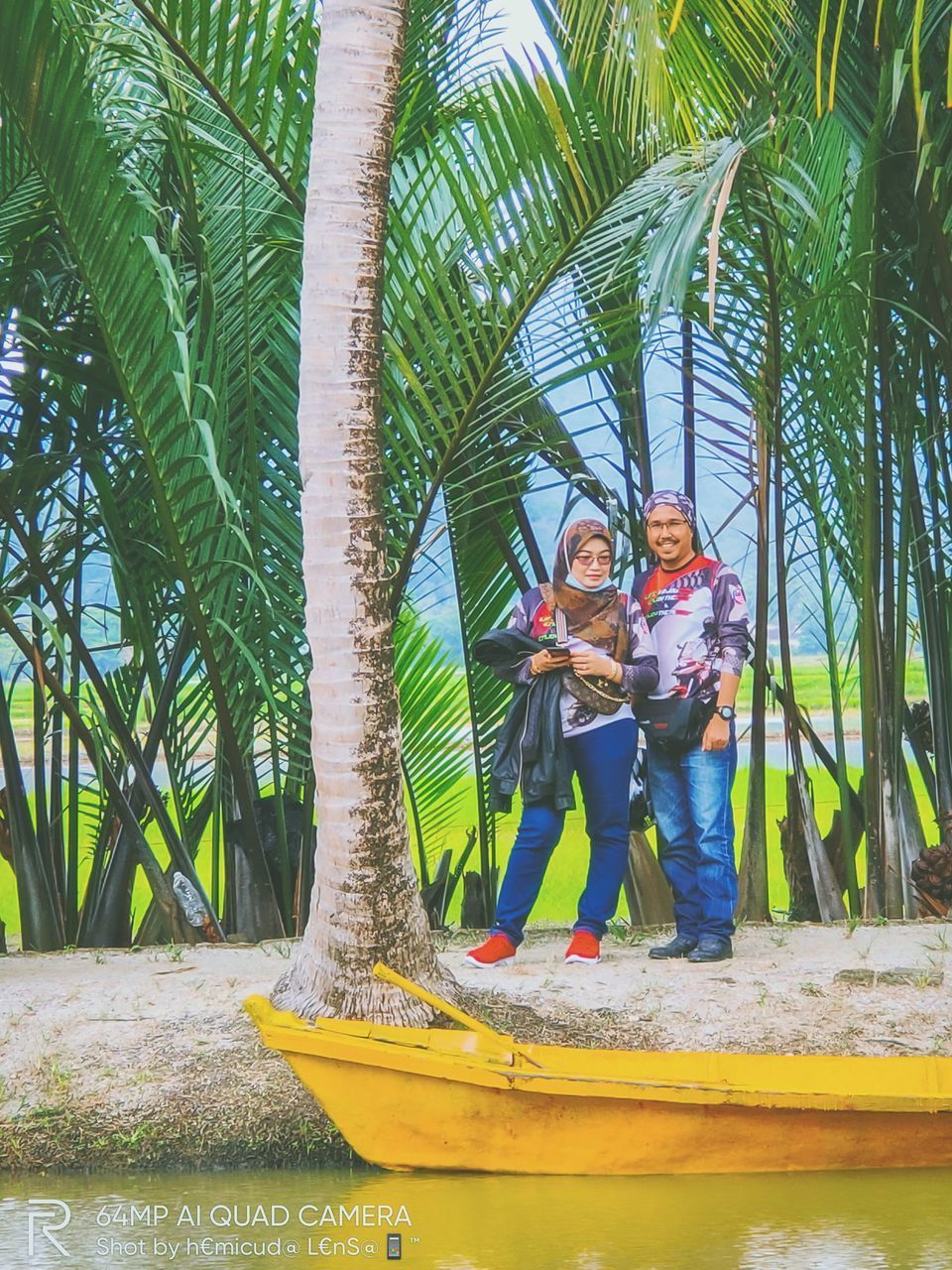 PEOPLE STANDING IN PALM TREES