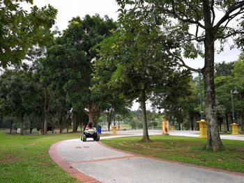 Girl riding beach buggy on footpath at park