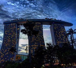 Low angle view of building against cloudy sky