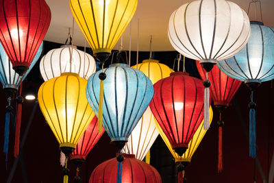 Low angle view of illuminated lanterns hanging at night