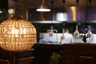 Close-up of illuminated lamp hanging on table