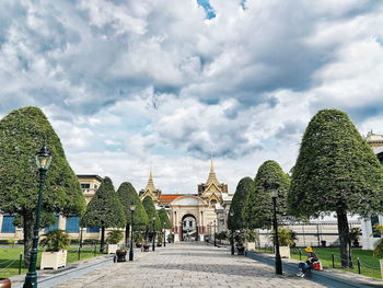 Buildings in city against cloudy sky