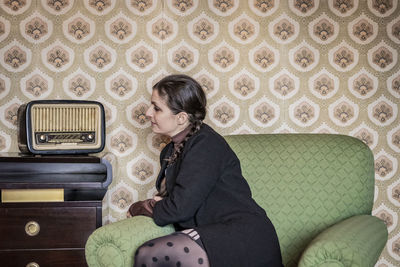 Woman sitting on sofa