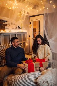 Young couple sitting at home