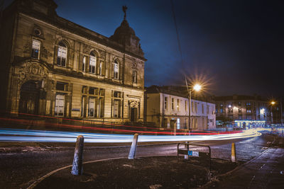 Illuminated city against sky at night