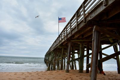 American flag in a blustery breeze at flagler beach pier