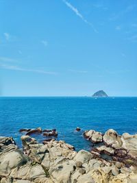 Scenic view of sea against blue sky