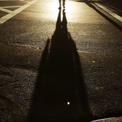 Shadow of people on road