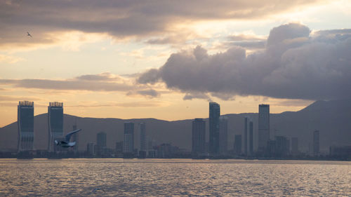 Scenic view of sea and buildings against sky