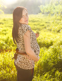 Midsection of woman standing on field