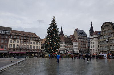 People in the city of strasbourg against sky, france