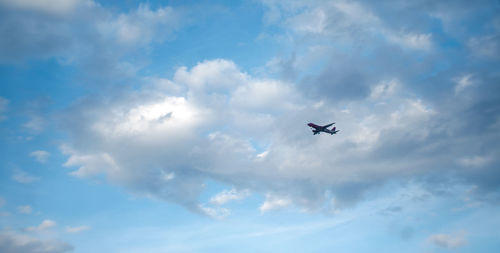 Low angle view of airplane flying in sky