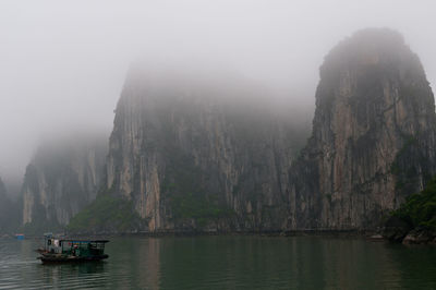 Scenic view of sea and mountains against sky