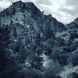 Low angle view of rocky mountain against sky