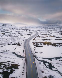 Snow covered road against sky