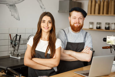 Portrait of smiling friends sitting at cafe