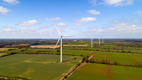 Windmill on field against sky