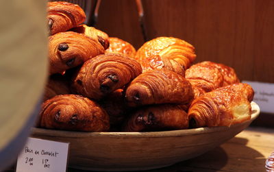 High angle view of fresh croissants in container on display at store