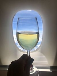 Reflection of person holding glass of wine