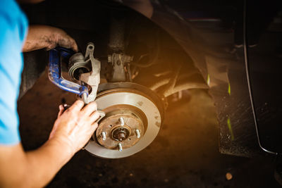 Midsection of man working on car