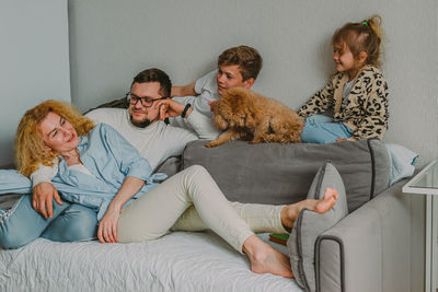 Portrait of family sitting on sofa at home