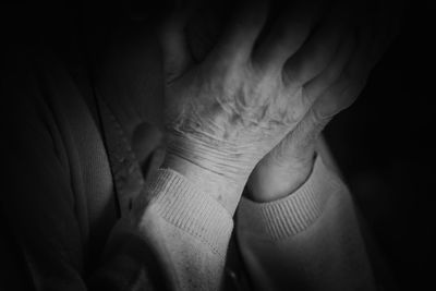 Close-up of sad senior woman covering face